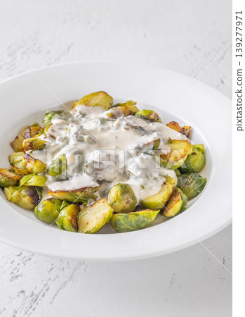 Roasted Brussels sprouts with creamy blue cheese sauce in white bowl Roasted Brussels sprouts with creamy blue cheese sauce in white bowl 139277971