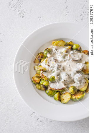 Roasted Brussels sprouts with creamy blue cheese sauce in white bowl Roasted Brussels sprouts with creamy blue cheese sauce in white bowl 139277972
