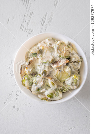 Roasted Brussels sprouts with creamy blue cheese sauce in white bowl Roasted Brussels sprouts with creamy blue cheese sauce in white bowl 139277974