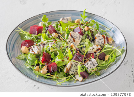 Beetroot arugula salad with blue cheese nuts and balsamic glaze Beetroot arugula salad with blue cheese nuts and balsamic glaze 139277978