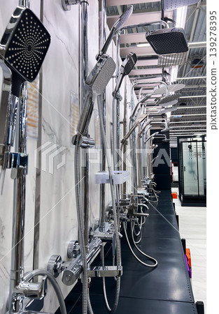 Rows of shiny chrome shower sets displayed in modern home improvement store. Variety of bathroom plumbing hardware for renovation and interior design. Selection of luxury equipment for home. Rows of shiny chrome shower sets displayed in modern home improvement store. Variety of bathroom plumbing hardware for renovation and interior design. Selection of luxury equipment for home. 139278395