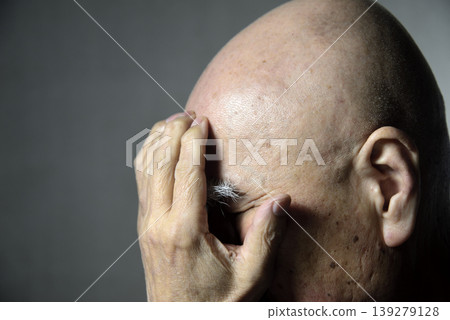 A bearded old man covering his face with his hands A bearded old man covering his face with his hands 139279128