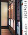 A traditional Japanese room with shoji screens and tatami mats bathed in sunlight. 139279643