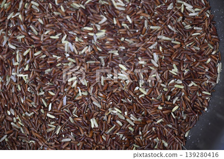 Organic brown rice raw grain healthy food closeup texture uncooked cereal natural ingredient vegan diet agriculture harvest Organic brown rice raw grain healthy food closeup texture uncooked cereal natural ingredient vegan diet agriculture harvest 139280416