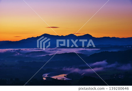 A sea of clouds and sunrise over the Echigo Sanzan mountains from Ojiya Yamamotoyama Plateau. 139280646