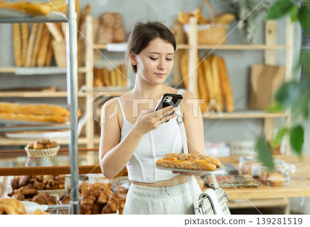 Girl customer holds bocadillo on disposable plate and recognizes it using app Girl customer holds bocadillo on disposable plate and recognizes it using app 139281519