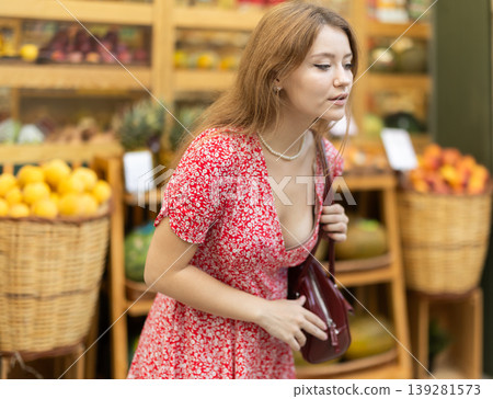 Pretty woman is looking for something at street market Pretty woman is looking for something at street market 139281573