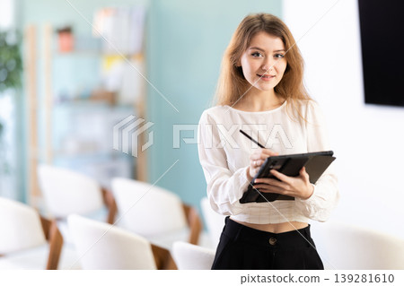 secretary woman with a tablet in her hands invites you to study secretary woman with a tablet in her hands invites you to study 139281610