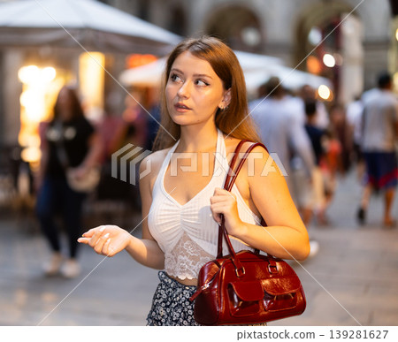 Woman walking around Barcelona, she has visited Placa real and plans to spend the evening in bars and restaurants with friends Woman walking around Barcelona, she has visited Placa real and plans to spend the evening in bars and restaurants with friends 139281627