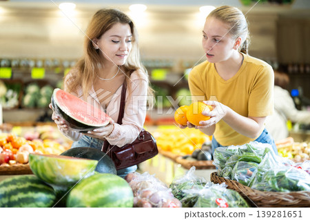 Two female shoppers choosing vegetables and fruits Two female shoppers choosing vegetables and fruits 139281651