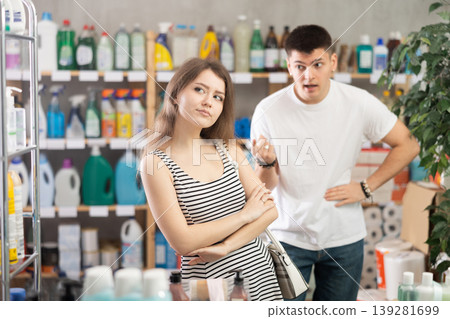 Guy yells at girl and reproaches her. Conflict during shopping, family disagreements Guy yells at girl and reproaches her. Conflict during shopping, family disagreements 139281699
