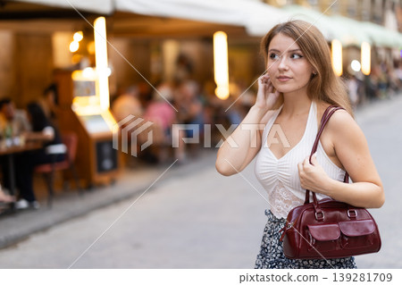 Young woman walking in Royal Square (Placa Real) in Barcelona Young woman walking in Royal Square (Placa Real) in Barcelona 139281709