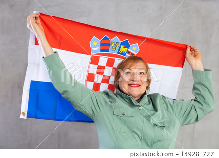 Cheerful senior woman standing confidently with croatian flag Cheerful senior woman standing confidently with croatian flag 139281727
