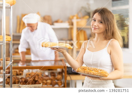 Young woman buyer with bocadillo in bakery Young woman buyer with bocadillo in bakery 139281751