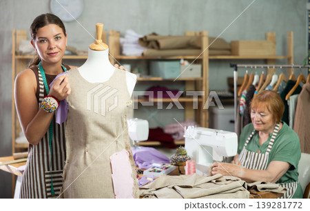 Woman working with mannequin against the background of an elderly dressmaker 139281772