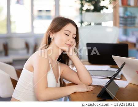 Tired young woman working with tablet in office 139281921