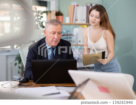 Young woman secretary brings papers and documents Young woman secretary brings papers and documents 139281940