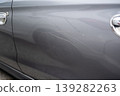 Close up of scratched gray car door with visible damage and dent 139282263