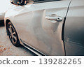 Close-up of Silver Car Door with Dent and Scratches 139282265