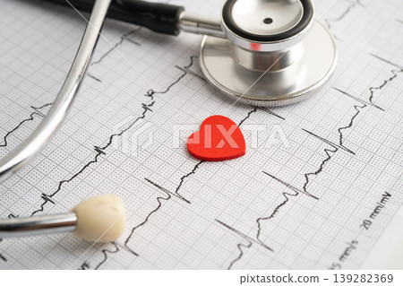 Red heart on electrocardiogram ECG with red heart, heart wave, heart attack, cardiogram report. Red heart on electrocardiogram ECG with red heart, heart wave, heart attack, cardiogram report. 139282369