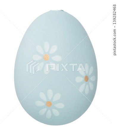 A light blue Easter egg with a cut-out daisy floral pattern on a white background. A light blue Easter egg with a cut-out daisy floral pattern on a white background. 139282468