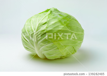 Side view of a whole cabbage with its outer leaves removed, placed against a white background. 139282485