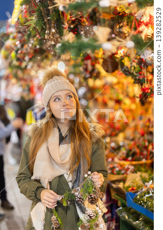 Woman standing at the market on Christmas evening Woman standing at the market on Christmas evening 139282529