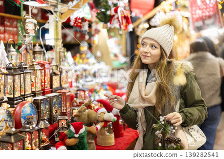 Young woman standing near shops at fair Young woman standing near shops at fair 139282541
