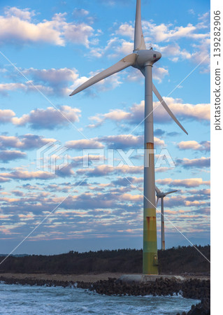 White wind turbines stand on the coast White wind turbines stand on the coast 139282906
