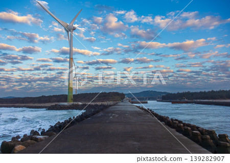 White wind turbines stand on the coast White wind turbines stand on the coast 139282907