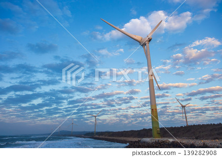 White wind turbines stand on the coast White wind turbines stand on the coast 139282908