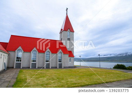 The church on a hill overlooking the fjord, Eyjafjörður, on the outskirts of Akureyri, in the Republic of Iceland, a Nordic island nation. The church on a hill overlooking the fjord, Eyjafjörður, on the outskirts of Akureyri, in the Republic of Iceland, a Nordic island nation. 139283775