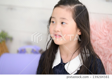 A Japanese girl practicing for her entrance exams. A Japanese girl practicing for her entrance exams. 139284381