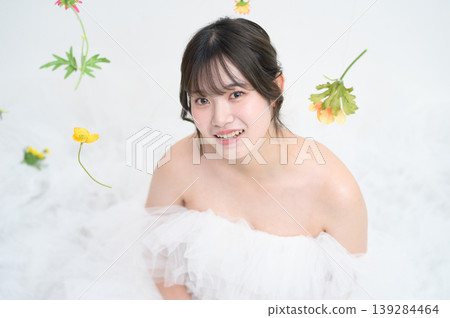 A Japanese woman in a wedding dress gazes out. 139284464