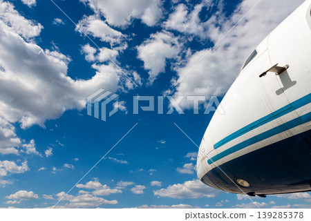 Passenger airplane nose against bright sky perspective 139285378