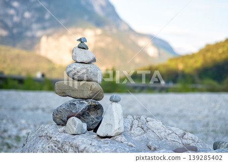 Balanced stone tower in mountain valley Balanced stone tower in mountain valley 139285402