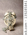 Alarm clock chained and locked, symbolizing limited time 139285841