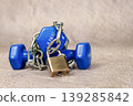 Dumbbell and padlock with chains symbolizing lockdown 139285842