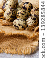Quail eggs resting on rustic burlap fabric 139285844