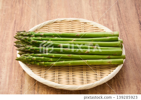 Fresh green asparagus, spring seasonal vegetables arranged on a bamboo sieve. Fresh green asparagus, spring seasonal vegetables arranged on a bamboo sieve. 139285923