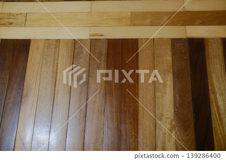 Shows varied wood planks in dark and light colors arranged as a floor Shows varied wood planks in dark and light colors arranged as a floor 139286400