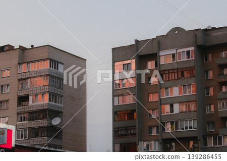 Late sunlight shines on apartment windows in an urban landscape Late sunlight shines on apartment windows in an urban landscape 139286455