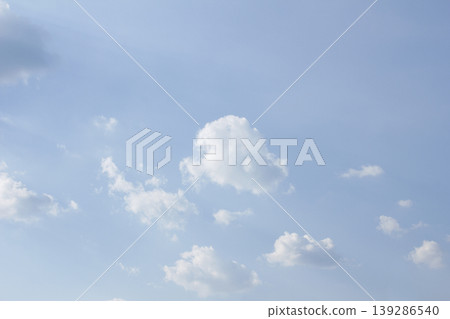 It's a blue sky with atmospheric puffy clouds. It's a blue sky with atmospheric puffy clouds. 139286540