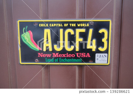 New mexico license plate with peppers and the text AJCF43 on a metal door 139286621