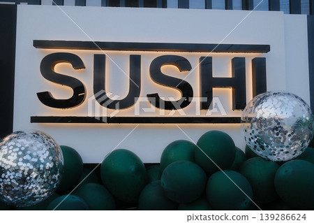 The Sushi sign stands above balloons and spheres, at a grand opening The Sushi sign stands above balloons and spheres, at a grand opening 139286624