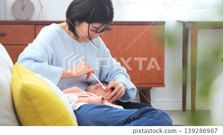 Image of a mother brushing her teeth Image of a mother brushing her teeth 139286987