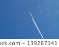 An airplane cloud extending into the blue sky 139287141