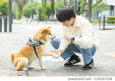 Lifestyle, Pets, A man walking his Shiba Inu 139287286