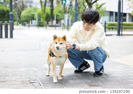 Lifestyle, Pets, A man walking his Shiba Inu 139287290
