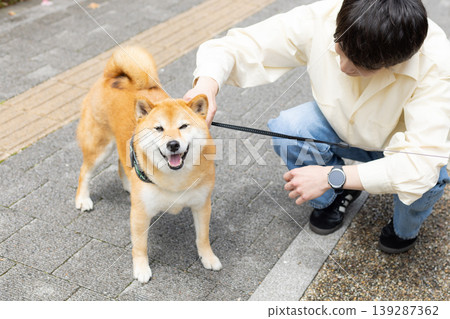 Lifestyle, Pets, A man walking his Shiba Inu 139287362